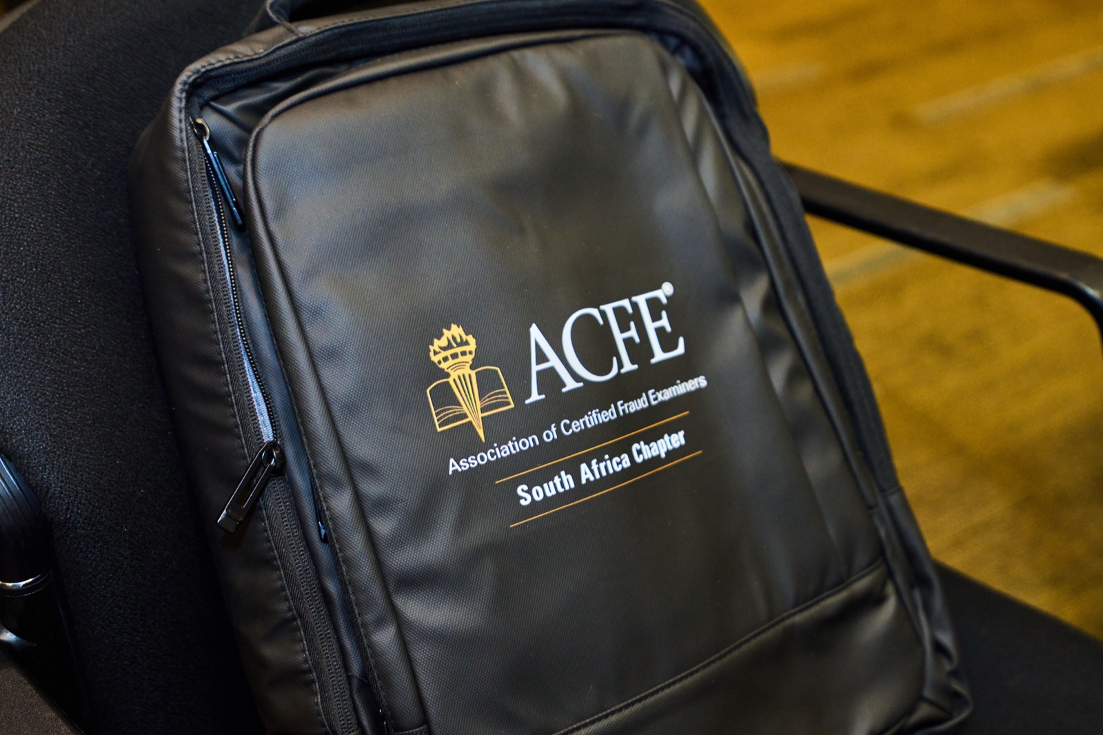A branded delegate bag on a conference chair