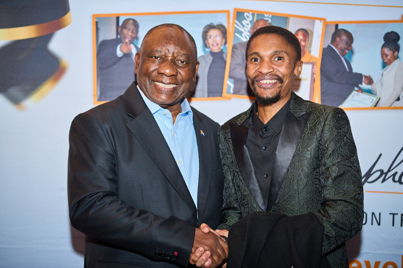 A handshake in front of the foundation backdrop