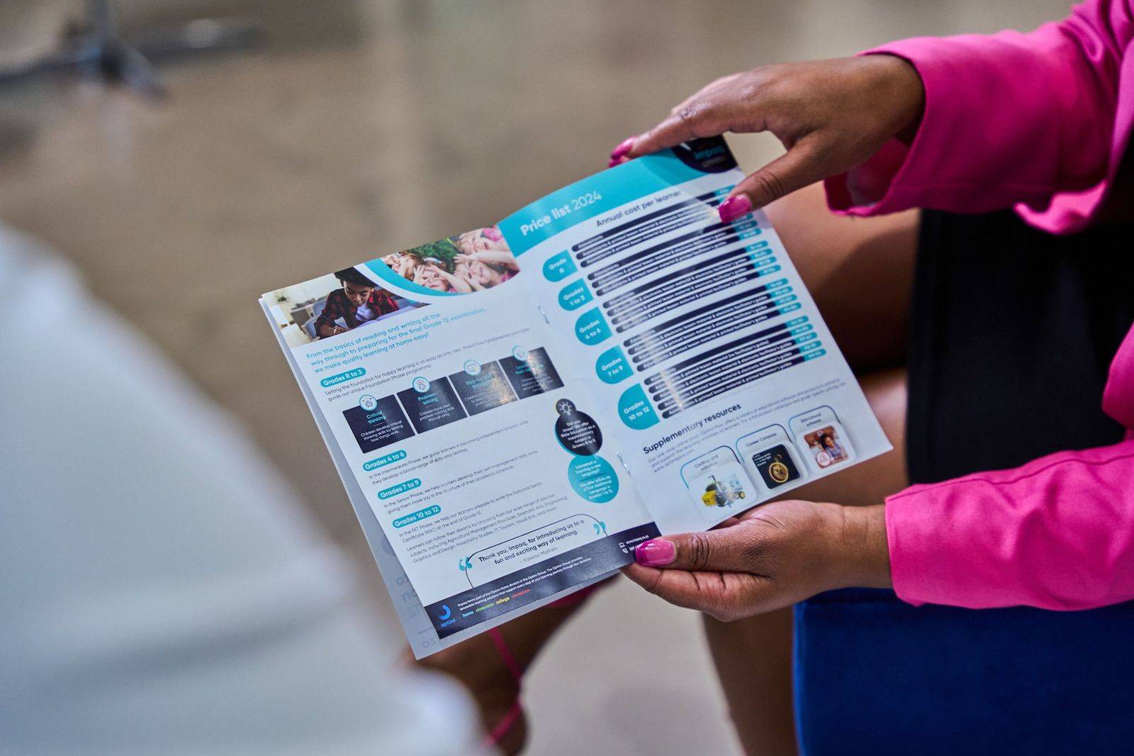 Hands holding a printed brochure