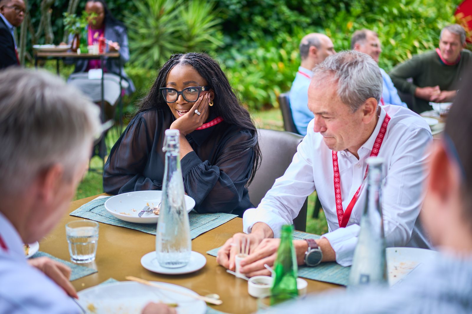 Guests talking over lunch outdoors