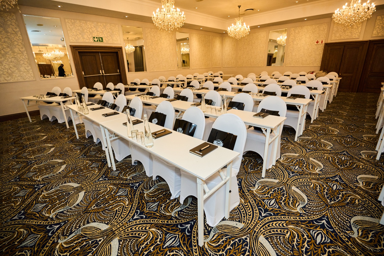 The room set before the delegates arrive, chandeliers lit