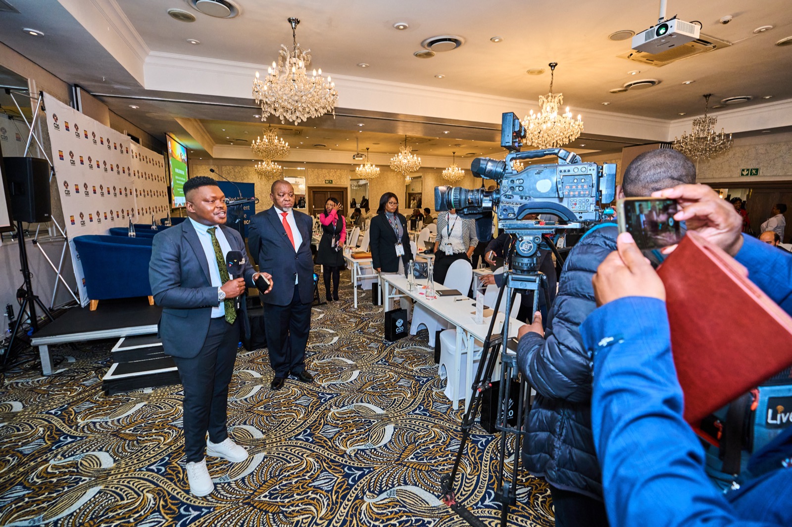A camera crew working the floor of a conference